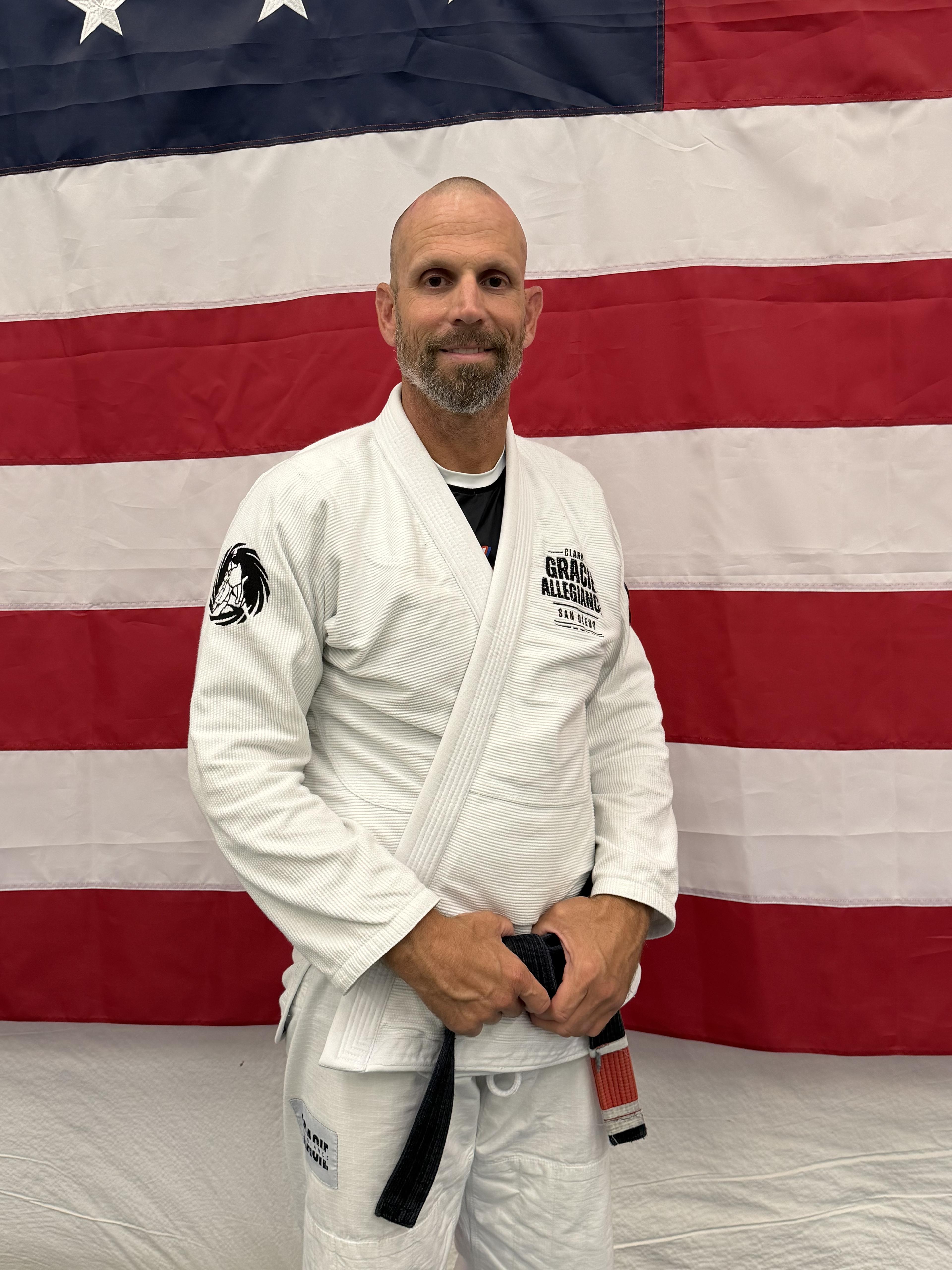 Professor Kevin Ross wearing a white gi and black belt at the academy