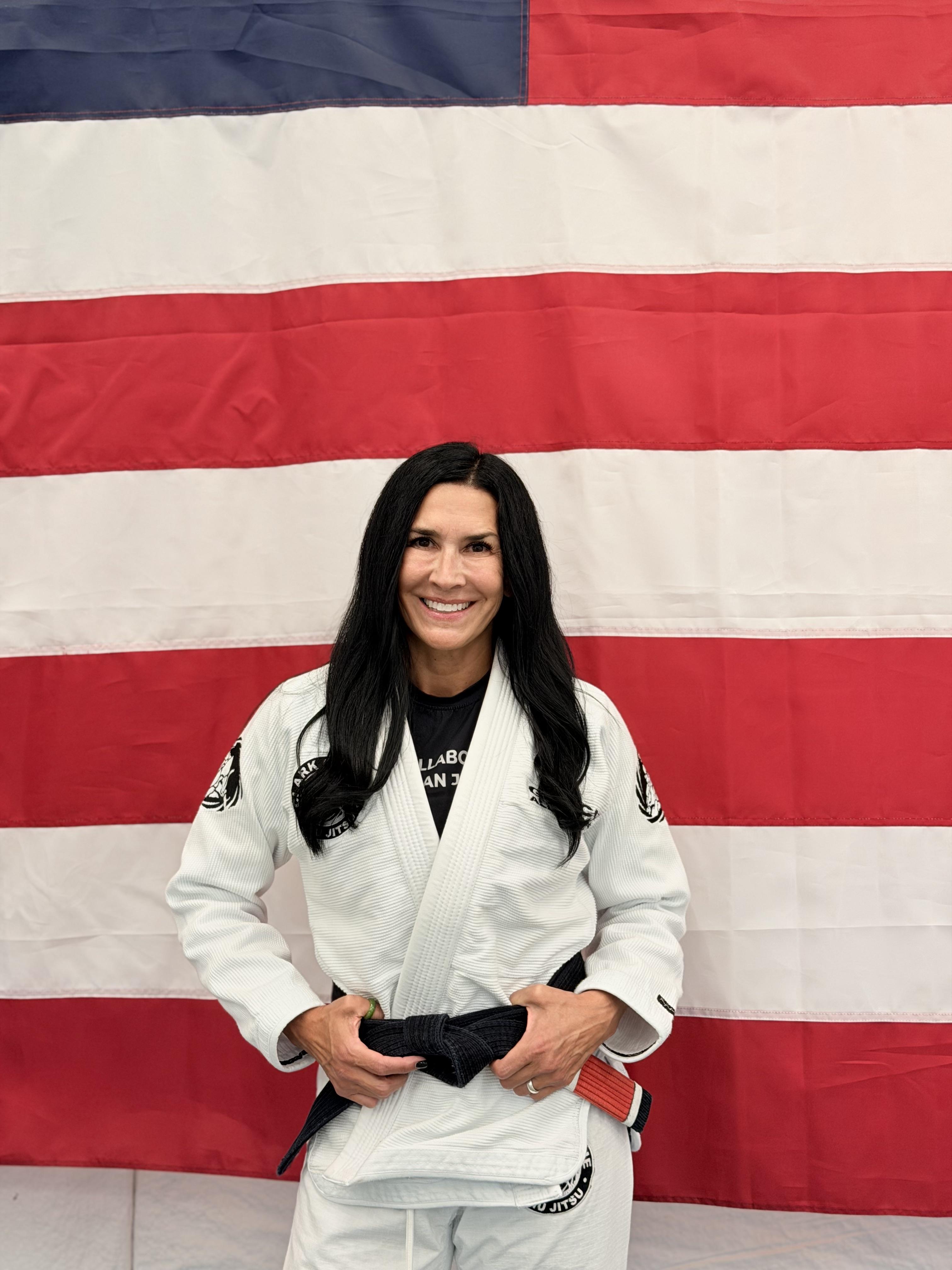 Ramona Ross wearing a white gi and black belt at the academy